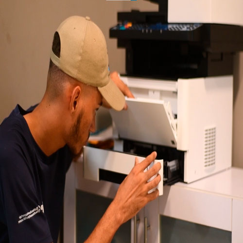 Técnico reparando una impresora multifuncional